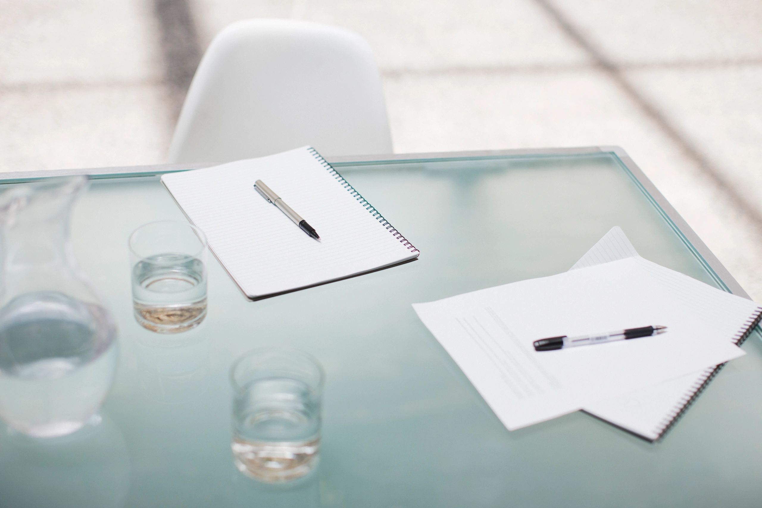 Notepads and pens on conference table